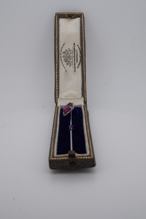 A North American? 10k white metal and single stone emerald cut synthetic ruby set stick pin, 55mm, gross weight 1.1 grams. Condition - fair to good